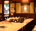 Warm and inviting restaurant interior with wooden tables and soft lighting, perfect ambience for dining.